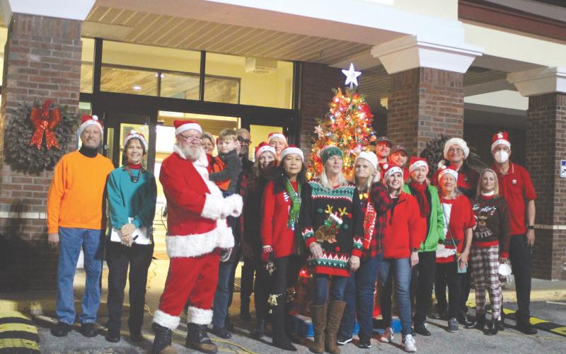 Megan Broome/The Clayton Tribune. Several volunteers in the community pass out presents, candy and Christmas cheer to children at the Christmas toy drive held at the Food Bank of Northeast Georgia last Friday.