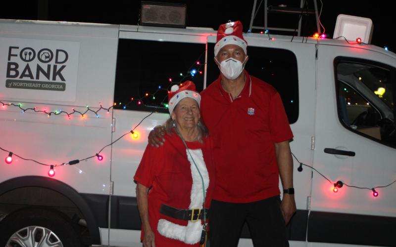 Megan Broome/The Clayton Tribune. Leckie Stack and James Brim, director of the Food Bank Mountain Branch, spent time at the Food Bank Saturday passing out gifts and candy to children for the Christmas toy drive held at the Food Bank of Northeast Georgia.