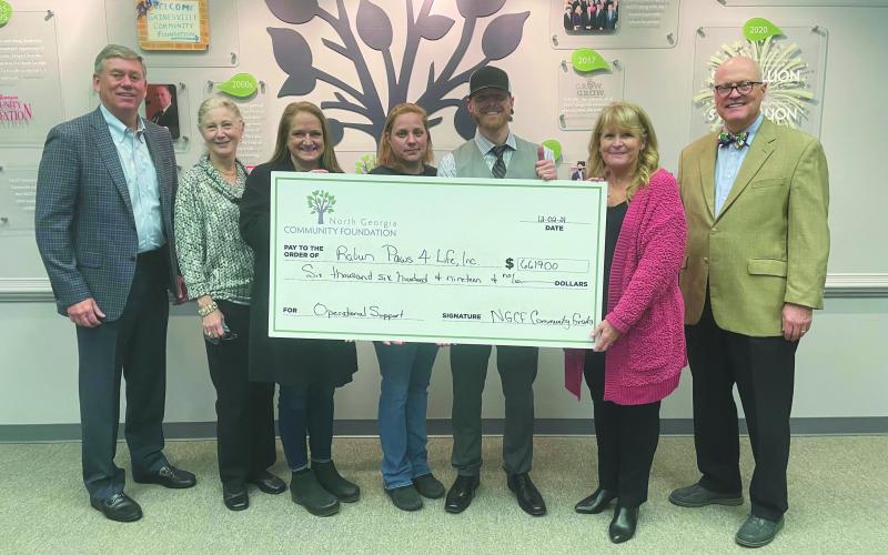 Photo submitted courtesy Margaux Dolenc. North Georgia Community Foundation board member Rob Fowler (from left); Debbie Dalhouse, Paws 4 Life volunteer; Jennifer Marcellino, Paws 4 Life CEO; Becca McClain, shelter director; Everett Lampros, shelter public relations manager; and Robert Shippey and Linda Foster, North Georgia Community Foundation board members, pose with a $6,619 North Georgia Community Foundation Grant check awarded to Paws 4 Life.