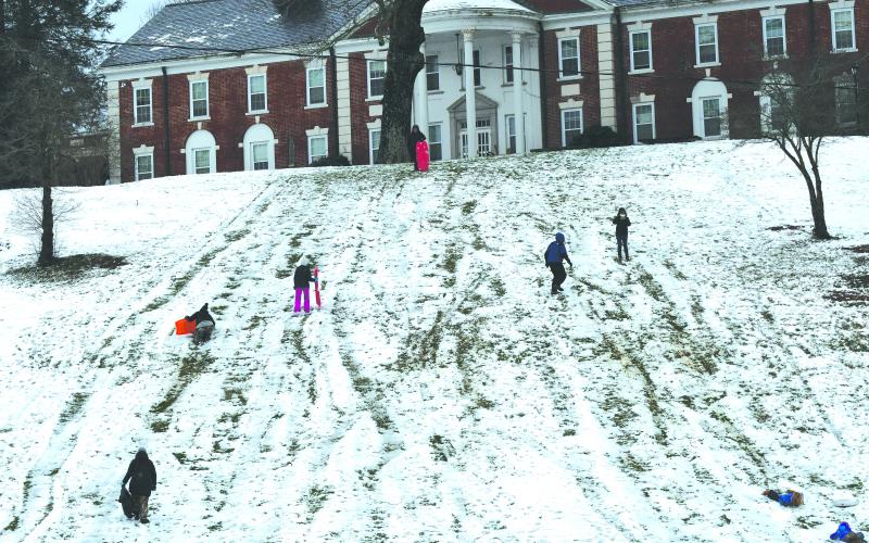 Enoch Autry/The Clayton Tribune. Hundreds took advantage of the snow on the big hill in front of Rabun Gap-Nacoochee School Sunday afternoon.