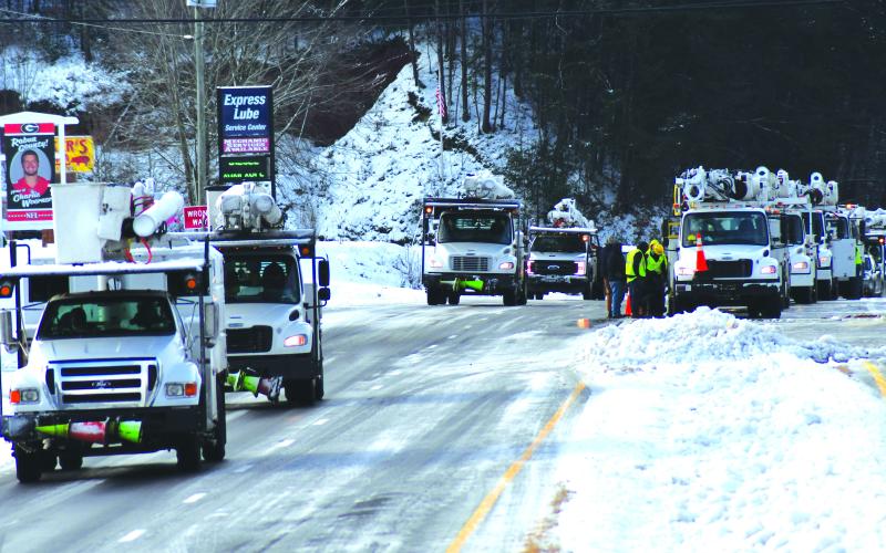 Enoch Autry/The Clayton Tribune. A line of utility trucks arrive in Clayton Monday to assist with power outages.