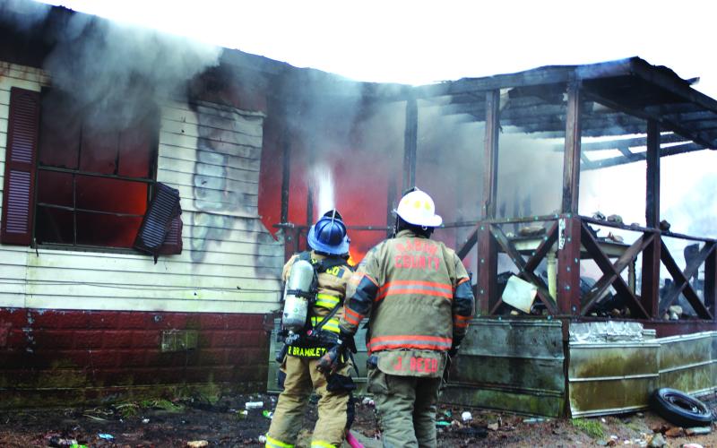 Megan Broome/The Clayton Tribune. Rabun County Fire Services work the scene of a structure fire at 453 Dan Crane Rd. Tuesday. No injuries were reported. The cause of the fire is under investigation.