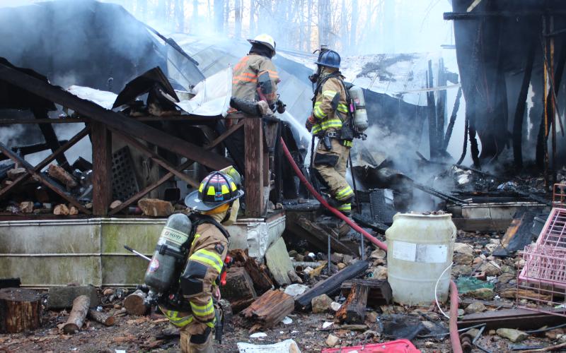 Megan Broome/The Clayton Tribune. Rabun County Fire Services work the scene of a structure fire at 453 Dan Crane Rd. Tuesday. No injuries were reported. The cause of the fire is under investigation.
