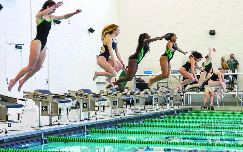 Photo courtesy of Austin Poffenberger. Emily Wolfe (from left), Karis Tatum, Daya Ssemakula, Tamia Moss, Hannah Hickox, Tillie Crumley and Montgomery Dampier jump into the pool after winning the girls’ 1A swimming championship.