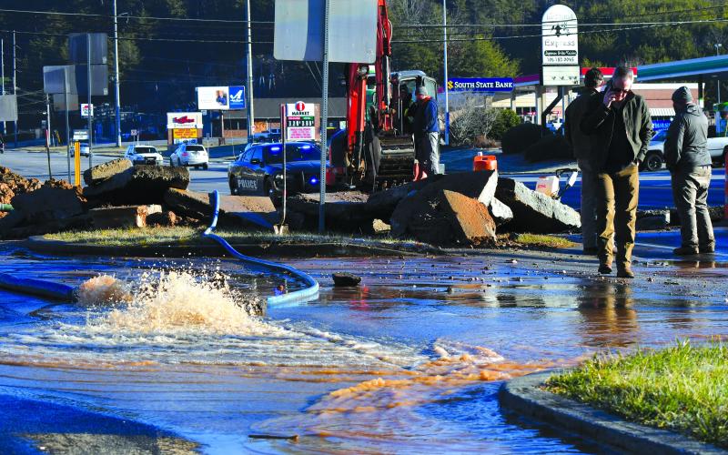 Enoch Autry/The Clayton Tribune. Water pours out into the parking lot from the Feb. 10 leak.