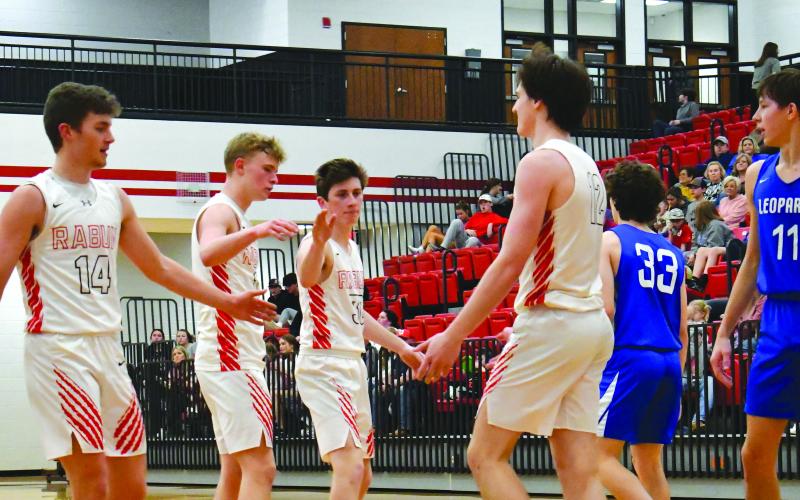 Enoch Autry/The Clayton Tribune. Connor McKay gets “fives” from his fellow Wildcats after scoring a layup. The region tourney begins today at home.