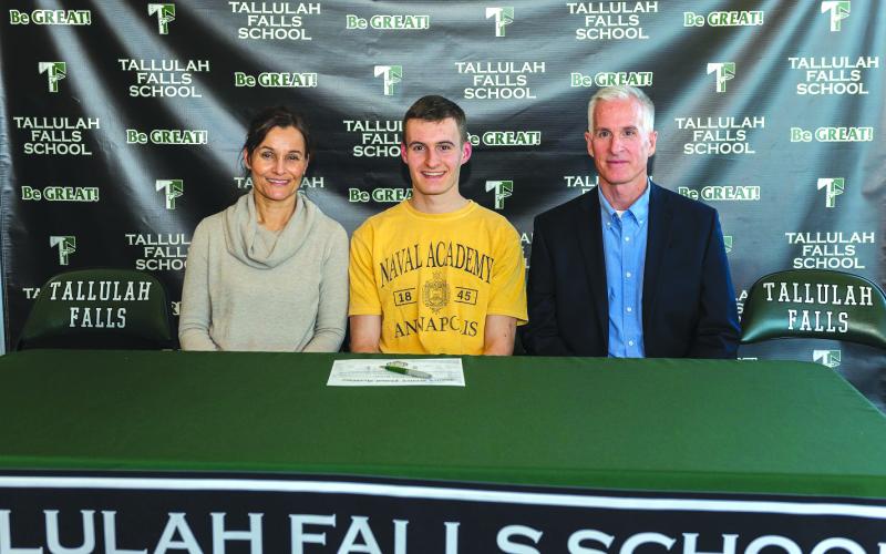 E.Lane Gresham/Tallulah Falls School. Tallulah Falls senior Evan Prince signed a national letter of intent with the U.S. Naval Academy Tuesday with his parents Debbie and George next to him.