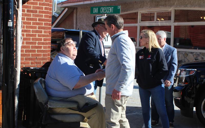 Megan Broome/The Clayton Tribune. Gov. Brian Kemp and Marty Kemp talk with Rabun residents during a meet-and-greet on Main Street in Clayton Feb. 18. Pictured are Ed Henderson, Rabun GOP secretary, Ed Fickey, Rabun GOP chair, and Rep. Stan Gunter.