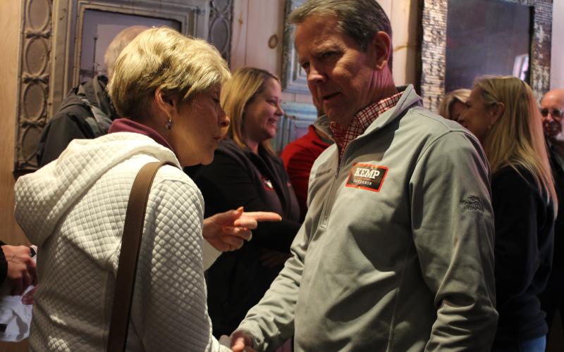 Megan Broome/The Clayton Tribune. Gov. Brian Kemp talks with Cassandra Clouser, Clayton DDA chair, at a meet-and-greet event in Clayton Feb. 18.