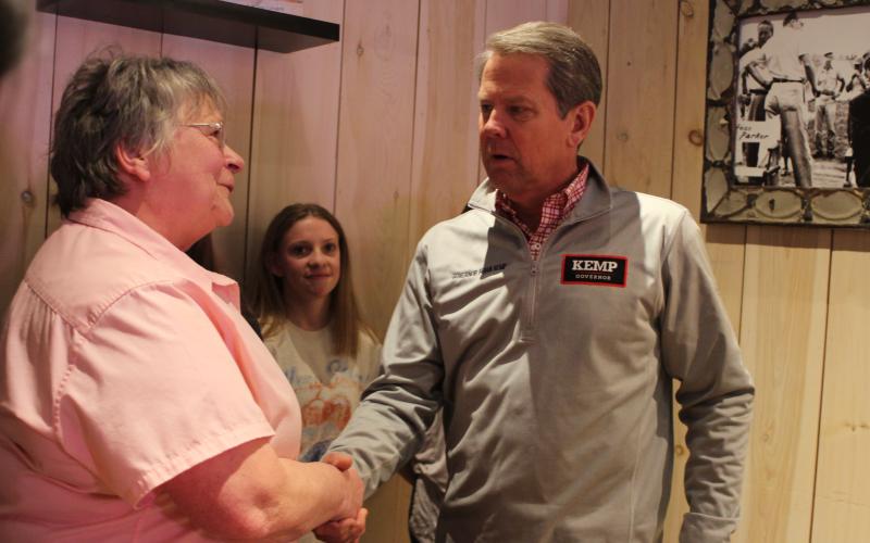 Megan Broome/The Clayton Tribune. Bonnie Edmonds, owner of Clayton Cafe, talks with Gov. Brian Kemp during a meet-and-greet at her restaurant in Clayton Feb. 18.