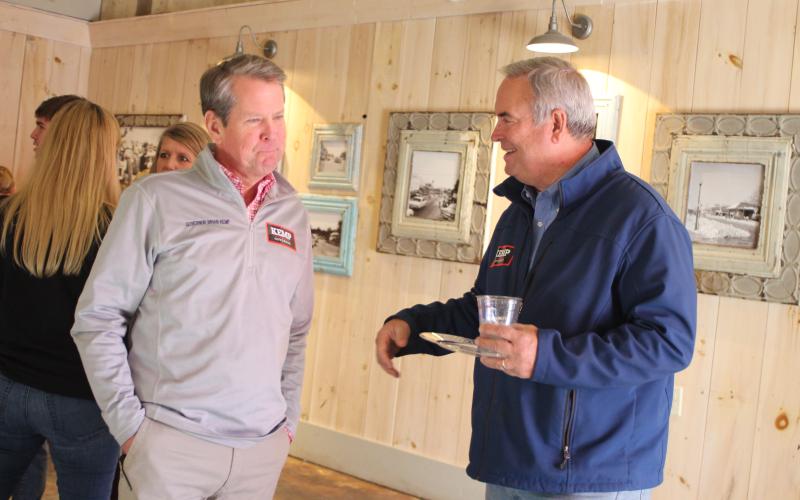 Megan Broome/The Clayton Tribune. Commissioner Kent Woerner talks with Gov. Brian Kemp during a meet-and-greet in Clayton Feb. 18.