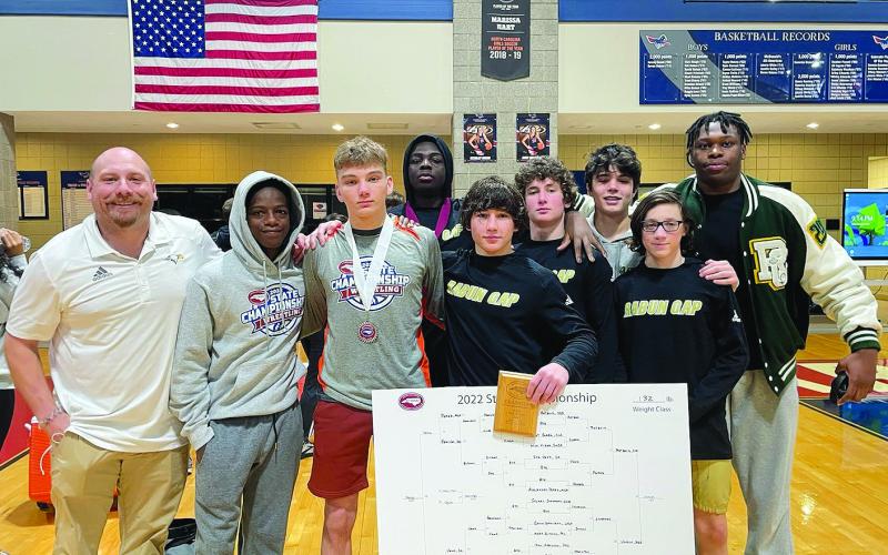 RGNS Atheltics. RGNS head wrestling coach Conor Bozzi (far left) stands with his team at state Benit Namahoro Jabo, Fisher Bejnerowicz, Mike Lengi, Clay Unruh, Cash Unruh, Rocco Toogood, Foster Duquette and Gideon Herbert.