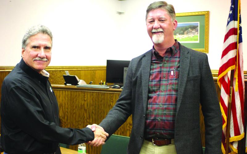 Megan Broome/The Clayton Tribune. After the Rabun County commission and Clayton city council unanimously vote Feb. 17 on a Service Delivery Strategy agreement, Commission Chair Greg James and Clayton Mayor Kurt Cannon shake on the decision.