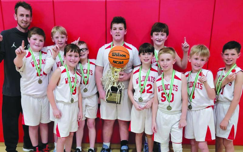 Submitted photo. The Rabun County 10-and-under boys recreation department basketball team won the county's first state Georgia Recreation and Park Association state championship on March 5. Pictured are the winning players and their trophy with Coach David Adcock. Not pictured is Coach Kristina Burrell.