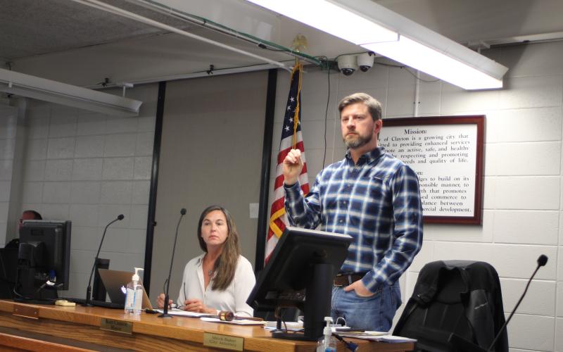 Megan Broome/The Clayton Tribune. Planning and Zoning Board member Sarah Gillespie, left, and Planning and Zoning Chair Joey Thompson speak to a crowded room of citizens at Monday’s hearing in the City of Clayton courtroom for a rezoning hearing for property located across from Clayton City Hall, 37 Bynum St./0 Holden st.  The hearing was to rezone the property from Residential Zone (R2) and Highway Business (HB) to Planned Unit Development (P.U.D.).