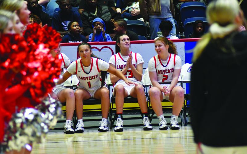 Enoch Autry/The Clayton Tribune. Ladycats await their names to be called as the starters.