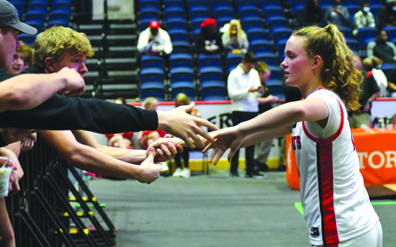 Enoch Autry/The Clayton Tribune.  Gus Hood holds the hand of his sister Ladycat Lucy Hood in encouragement as Rabun County comes out of the locker room for the second half.