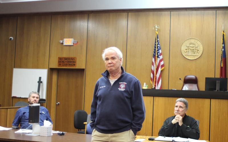 Megan Broome/The Clayton Tribune. Firefighter Gordon Van Mol addresses fellow first responders and attendees during a presentation at the Rabun County Board of Commissioners meeting Feb. 22 and thanks them for saving his life after he went into cardiac arrest while battling a brush fire Nov. 27. The first responders were presented with plaques for their heroic efforts. “These people are at their best when you are at your worst,” a tearful Van Mol said.