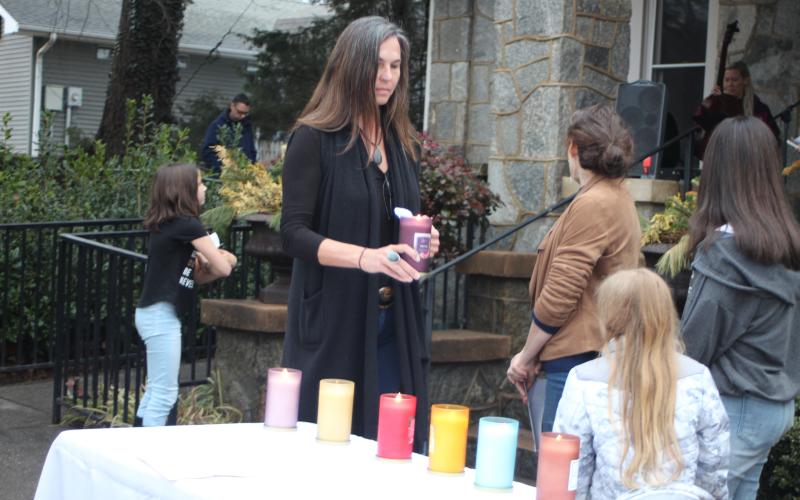 Megan Broome/The Clayton Tribune. Sarah Gillespie lights a candle in honor of those who have suffered from and lost their lives to mental illness. A candlelight service and Mental Health March hosted by Georgia Mountain Psychological Associates were held Feb. 22 to remember those who have lost their lives to mental illness.