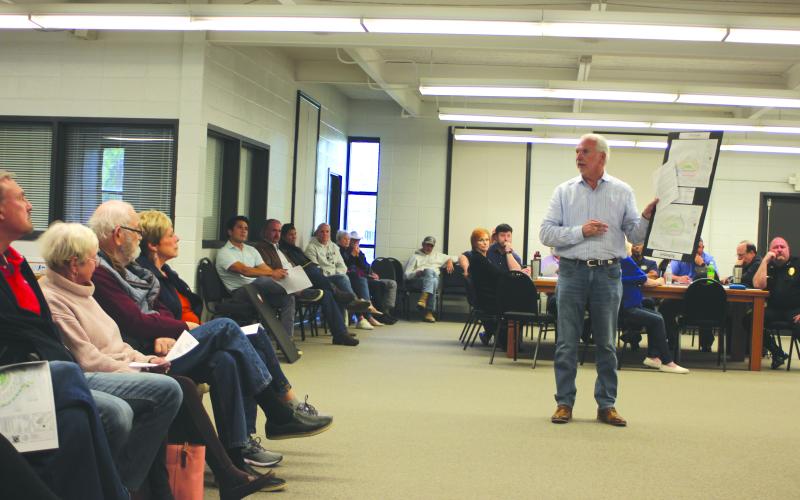 Megan Broome/The Clayton Tribune. Milton Garland, Sr., president of Garland Contractors Inc., who is the contractor for the 91-unit development across from Clayton City Hall, addresses a crowded room at the Clayton City Council meeting Tuesday and discusses amenities and site plans for the development. The council later in the meeting approved a rezoning of the property to P.U.D and approved site plans with conditions for lighting and landscaping.