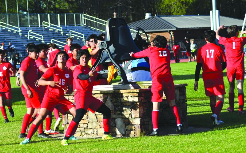 Enoch Autry/The Clayton Tribune. The Wildcats ring the bell after winning the state tourney game.