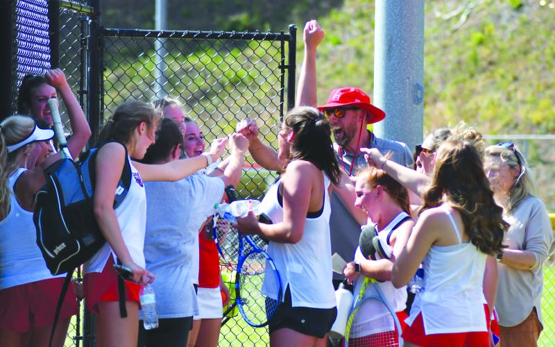 Enoch Autry/The Clayton Tribune. With RCHS head coach Bryan Getty, the Ladycat tennis team celebrates its 3-1 win over visiting Bacon County to advance to the Class AA Elite Eight. RCHS plays at fellow No. 1 seed Berrien Monday morning.