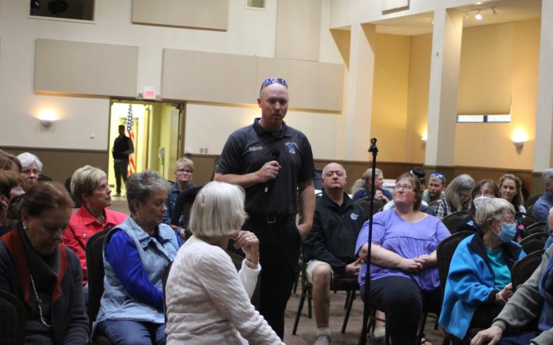 Megan Broome/The Clayton Tribune. Paramedic David Cavender speaks at the forum held at the Rabun County Civic Center April 21. He talked about the struggle for emergency services to meet the demand of the fast growth in the county, due to limited staff and resources. He asked commissioners if they are working on a solution to the problem. The forum was organized to highlight the need for housing in Rabun County.