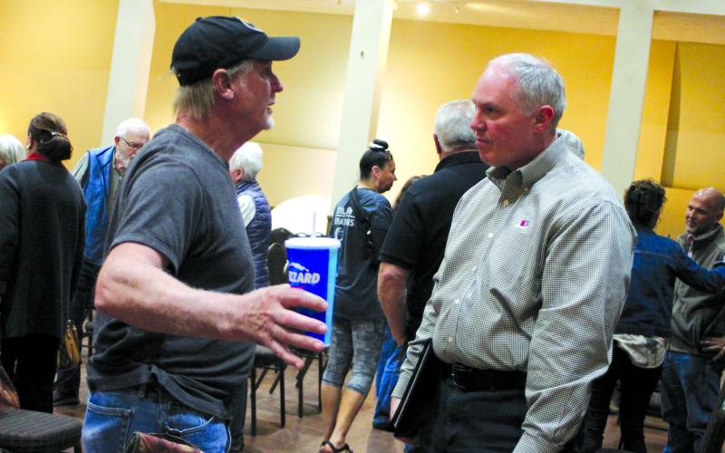 Megan Broome/The Clayton Tribune. Mike Setzer talks to Rick Story, director of development for Rabun County, following the forum  held at the Rabun County Civic Center April 21. Setzer spoke with Story about his struggles and concerns as a landlord.  The forum was organized to highlight the need for housing in Rabun County.