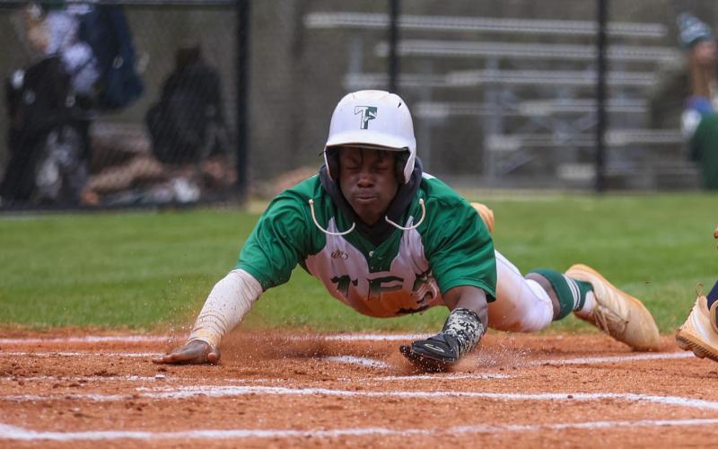 Photo by Austin Poffenberger. Joel Miller slides in safely at home for the Tallulah Falls Indians.
