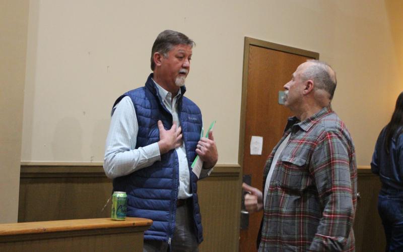 Megan Broome/The Clayton Tribune.  Steven Kilpatrick, right, talks to Clayton Mayor Kurt Cannon, who was one of the speakers at the public forum held by the Rabun County Coalition for Good Government at the Rabun County Civic Center Monday night. The purpose was to spark participation in government and discussion on the topics related to the city of Clayton’s zoning ordinances and what is being done to minimize the impact of the 91-unit development.