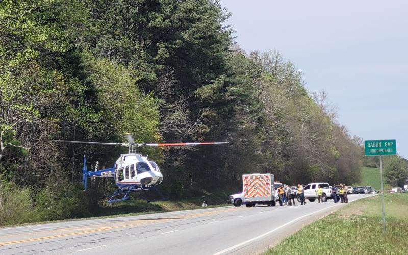 Megan Broome/The Clayton Tribune. A helicopter leaves from the roadway with an injured person from the April 15 crash.