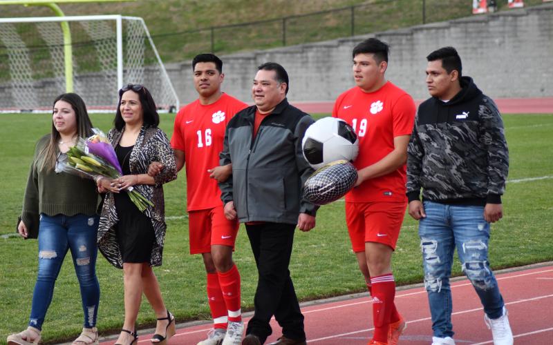 Enoch Autry/The Clayton Tribune.  RCHS Wildcat senior Paco Balderas (16) is escorted by his family for the “Senior Night” ceremony between the girls and boys games at the stadium.