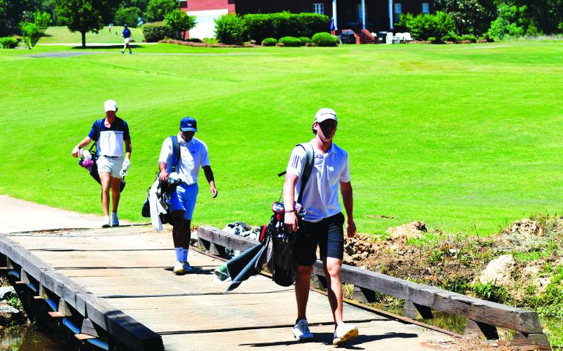 Enoch Autry/The Clayton Tribune. Connor Horton walks across the bridge at Southern Hills as he makes his way to the 18th hole Tuesday.