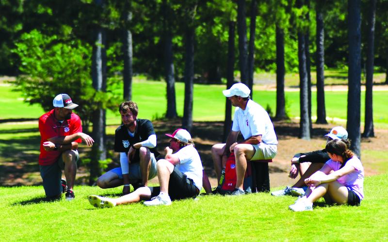 Enoch Autry/The Clayton Tribune. RCHS golf coach David Adcock talks with team members and fans who made the four-hour trip to state.