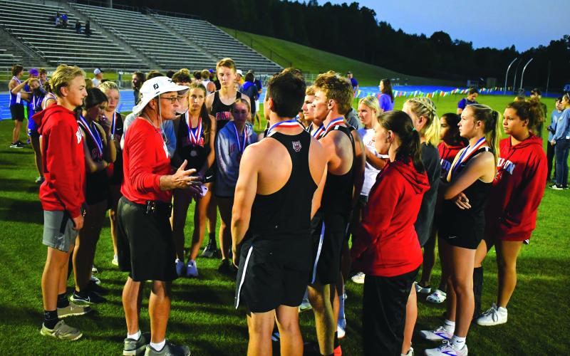 Enoch Autry/The Clayton Tribune.  Stockel talks with track team members after Region 8-AA meet.