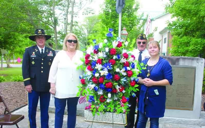 Megan Broome/The Clayton Tribune. Roger Glenn, United States Army Military Police Officer, Cindy O’Neil, Chris Dinofrio and Crystal Zajdowicz Cross place a wreath in honor of the men and women who fought and died for our country. Glenn was the speaker at the event.