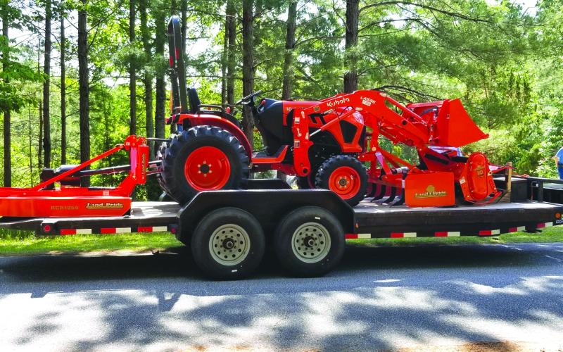 Submitted photo. The tractor with its bush hog is shown on its trailer.