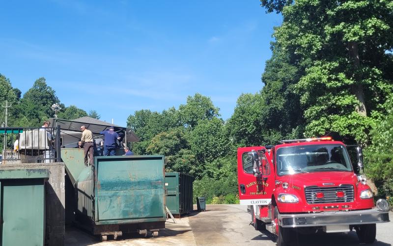 Megan Broome/The Clayton Tribune. Rabun County first responders work to rescue a woman who fell into a trash compactor while working at the Chechero Recycling Center Monday.