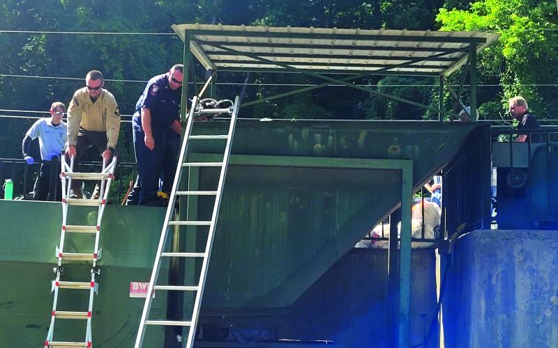 Megan Broome/The Clayton Tribune. Rabun County first responders work to rescue a woman who fell into a trash compactor while working at the Chechero Recycling Center Monday.