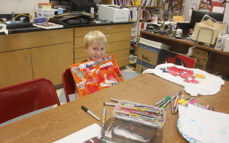 Megan Broome/The Clayton Tribune. Hayes Ward, 6, shows his art project he made during Mrs. Jarrard’s Art Camp last week.