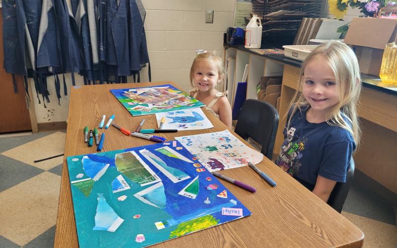 Megan Broome/The Clayton Tribune. Sisters Evelly Youngblood, 5, and Emsley Youngblood, 8, color outside of the lines and display their creativity during Mrs. Jarrard’s Art Camp in the Fine Arts Building at Rabun County High School last week.