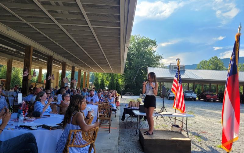 Megan Broome/The Clayton Tribune. Bee Nguyen, candidate for Georgia Secretary of State against Republican Brad Raffensperger, speaks to attendees about redistricting, combating voter suppression laws, and the importance of free, fair and efficient elections and protecting the strength of Democracy, at the Fourth Annual Blue BBQ hosted by the Rabun County Democrats at the Rabun County Pavillions in Clayton July 23.