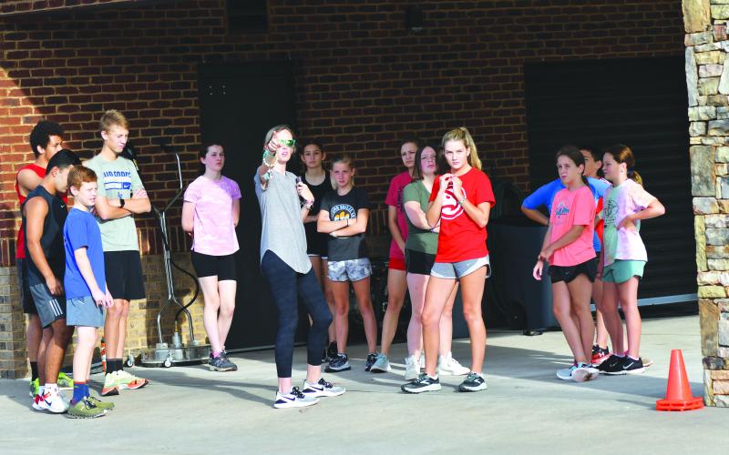 Enoch Autry/The Clayton Tribune. RCHS cross country head coach April Adcock directs her runners on a selected route on the campus.