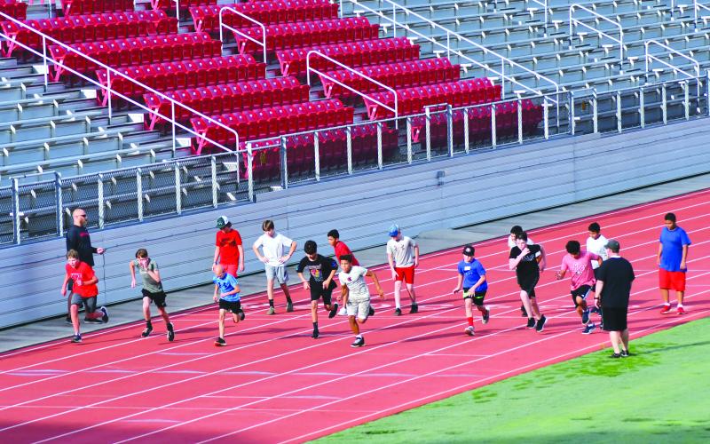 Enoch Autry/The Clayton Tribune. With coaches watching, student-athletes get in some early morning sprints at Rabun County High School.