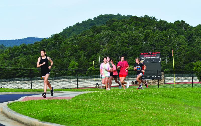 Enoch Autry/The Clayton Tribune. Rabun County Middle School cross country girls run at the high school.