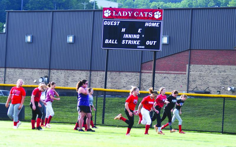 Enoch Autry/The Clayton Tribune. Kelli Welch works with RCMS softball players.