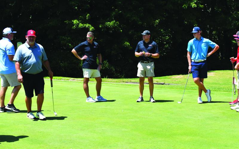 Enoch Autry/The Clayton Tribune. Players spend some time on the practice putting greens at Kingwood Resort Golf Course prior to the start of the inaugural Rabun County Booster Club Wildcat Open Golf Tournament on July 22. The event raised more than $9,000 to go toward the sports teams at the middle school and high school.