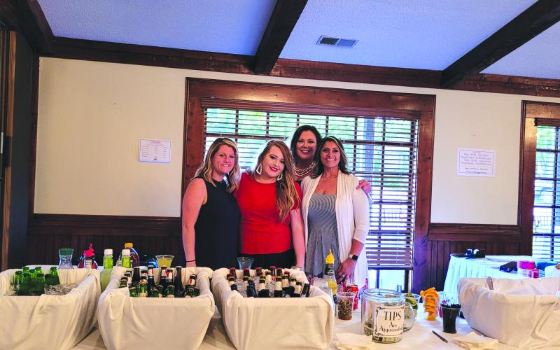 Megan Broome/The Clayton Tribune. Andria Robinson, Ashley Cabe, Natalie Dillard and Jo Flores work hard as they listen to the live music and enjoy the festivities at The Dillard House on Sunday.