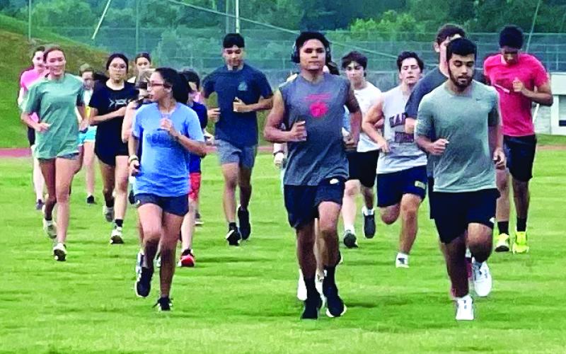 Enoch Autry/The Clayton Tribune. The cross country members get in their summer conditioning work on the Rabun County High School campus.