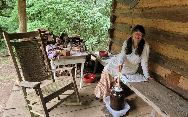 Megan Broome/The Clayton Tribune. Cathy Stiles demonstrates how to make butter and cream during the Foxfire Heritage Days event.